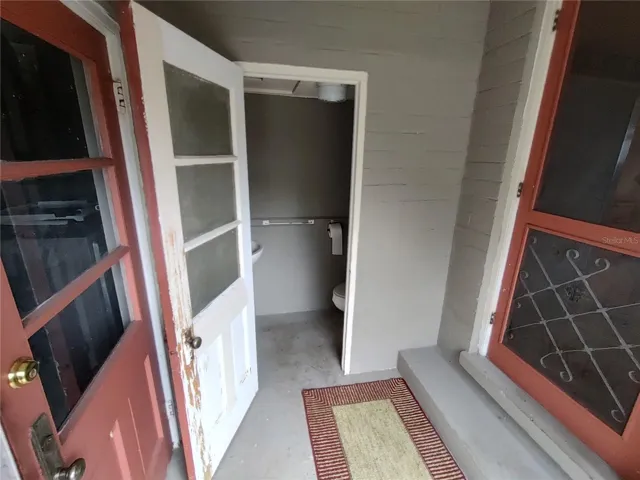 Half bathroom between the kitchen and garage