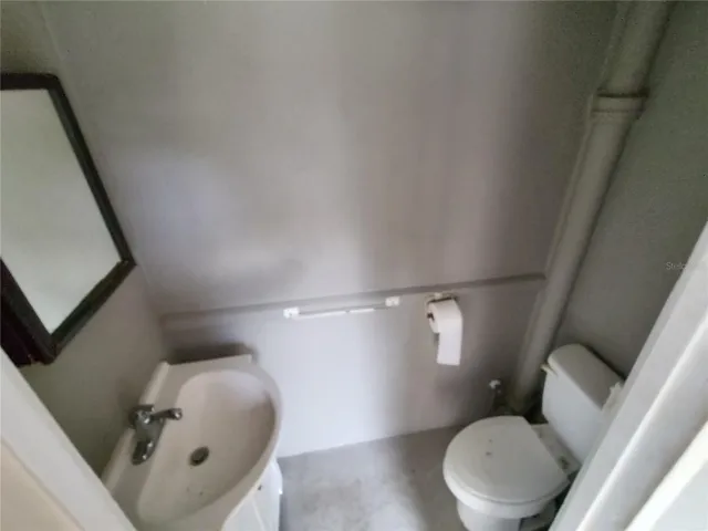 Half bathroom between the kitchen and garage