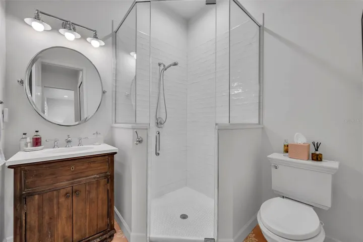 The private en-suite bath with custom tile and a walkin shower
