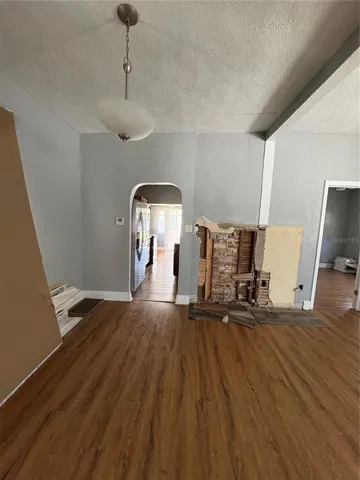 From front door to view of primary bedroom and kitchen