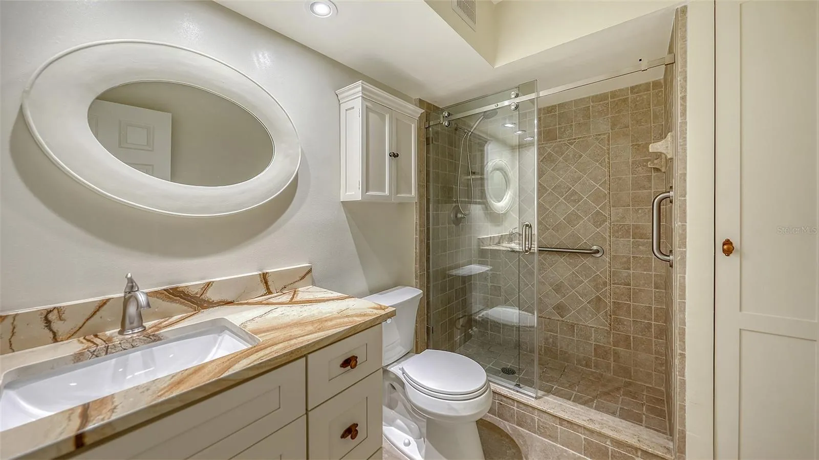Updated primary bathroom with granite counters, new fixtures, &amp; soft close cabinetry.
