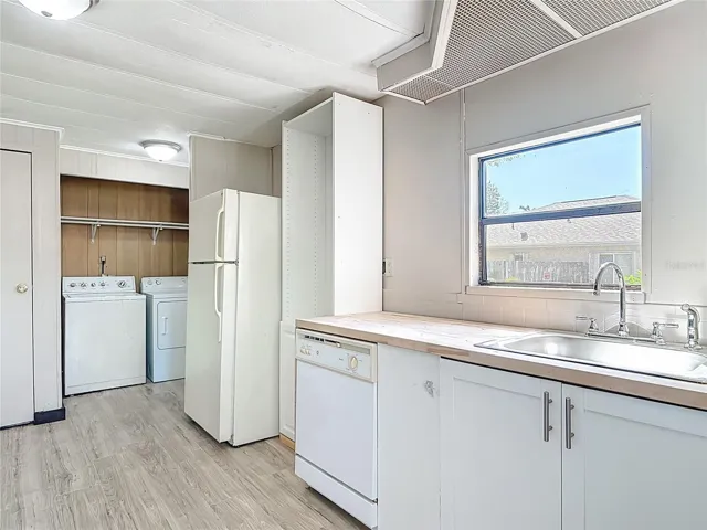 kitchen has the washer and dryer in a closet