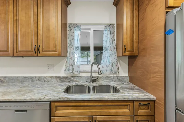 Double sink and view of the pool with pass through impact window