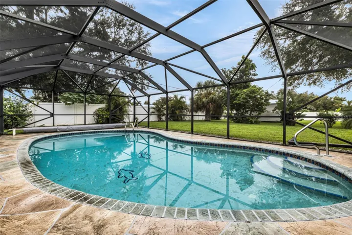 Heated Gunite pool with privacy fencing and solar cover