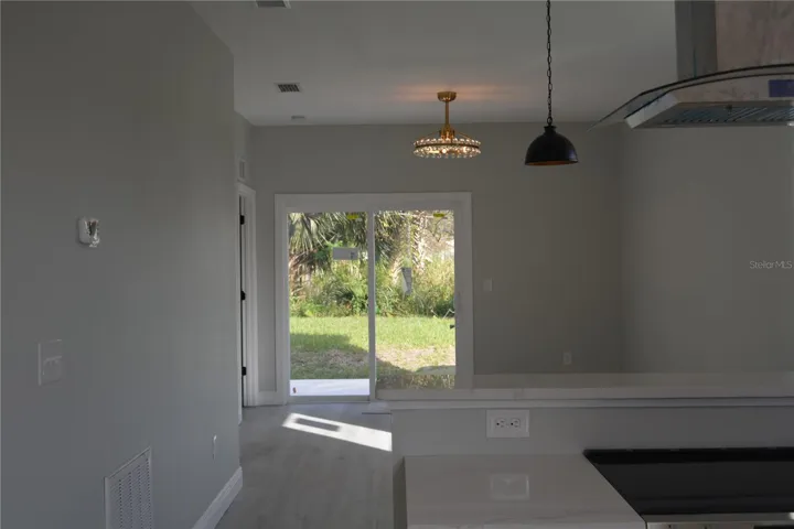 view from the kitchen looking towards the back double slider doors