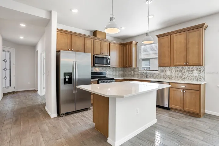 Kitchen showing Kitchen eat in island & upgraded wood look tile.