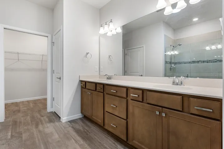 Master bathroom , quartz counter top vanity, round dual sinks & walk in closet.