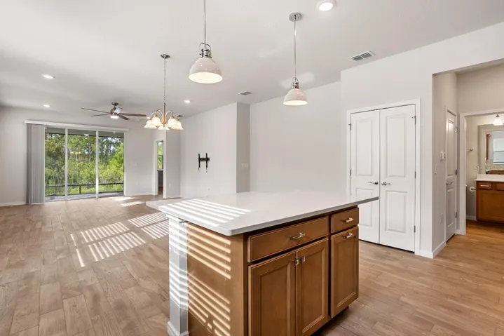 View from kitchen down to the glass slider  7 out to the lanai. Note the closet pantry.