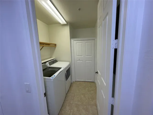 Laundry room with closet