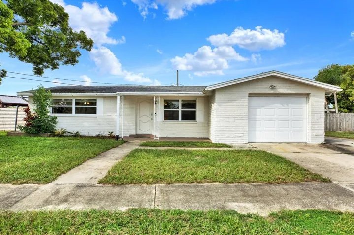 Front of home with garage nice yard
