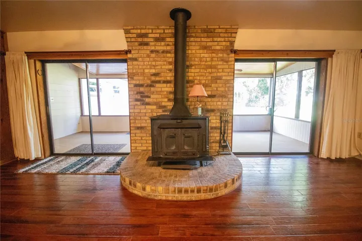 Living room with wood burning fireplace.