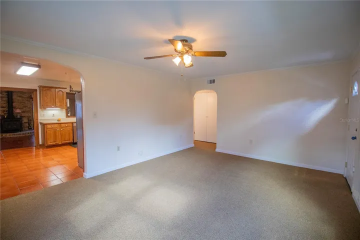 View of the Kitchen from the Living room with carpet.