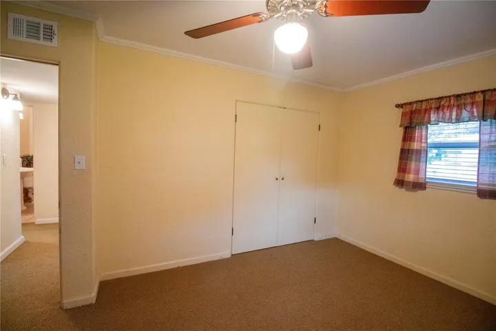Bedroom Two with carpet and a Ceiling Fan.