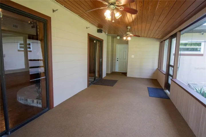 Screened in Patio with  wood ceiling and two ceiling fans.