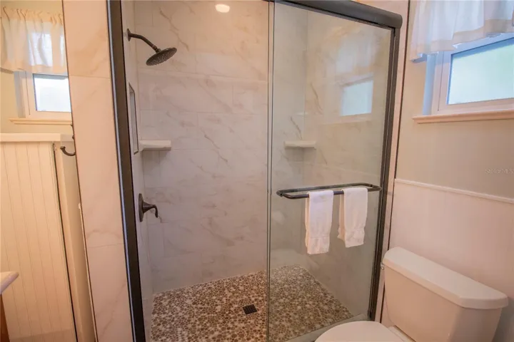 Primary Shower Remolded with Pebbled Floor and Tile.