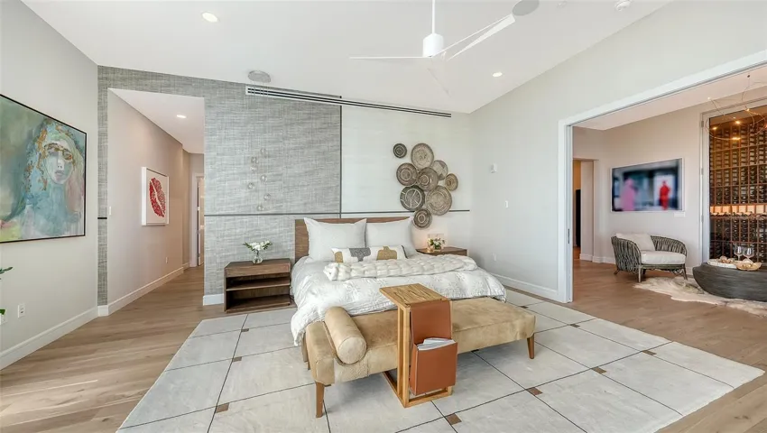Primary bedroom is perfectly appointed with a feature wall to exude natural elegance and warmth. The cozy nook adjacent to your room is a perfect spot for a quiet chat or glass of wine.