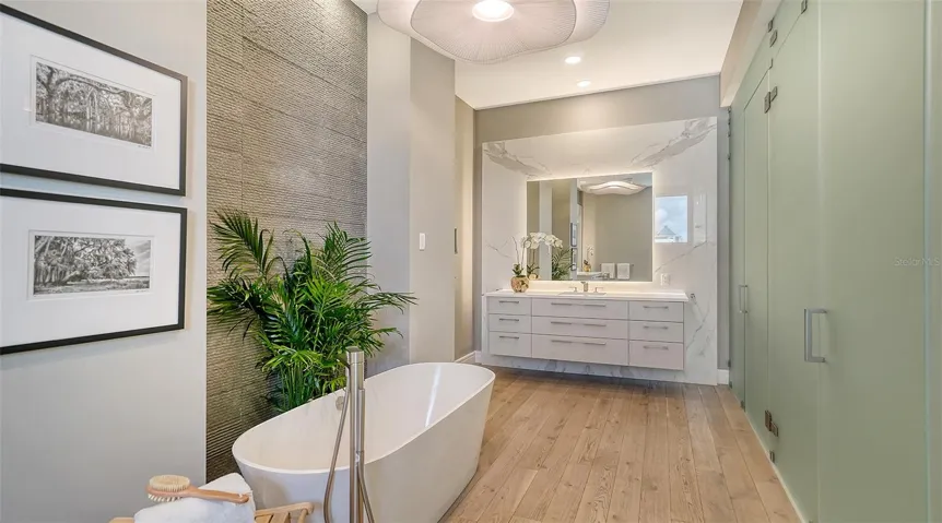 Primary Spa bathroom with walk in shower, dual water closets, and a large soaking tub featuring solid plumbing fixtures by Dornbracht™ &amp; Hansgrohe™