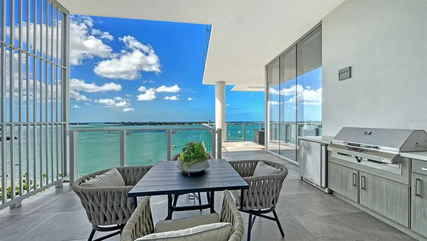 Private balcony adjacent to the kitchen provides an intimate al fresco dining spot, complete with stainless grill, NatureKast™ cabinetry and a beverage refrigerator