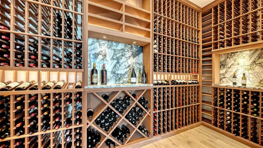 1600 bottle capacity wine room has temperature control and rich marbel accent walls