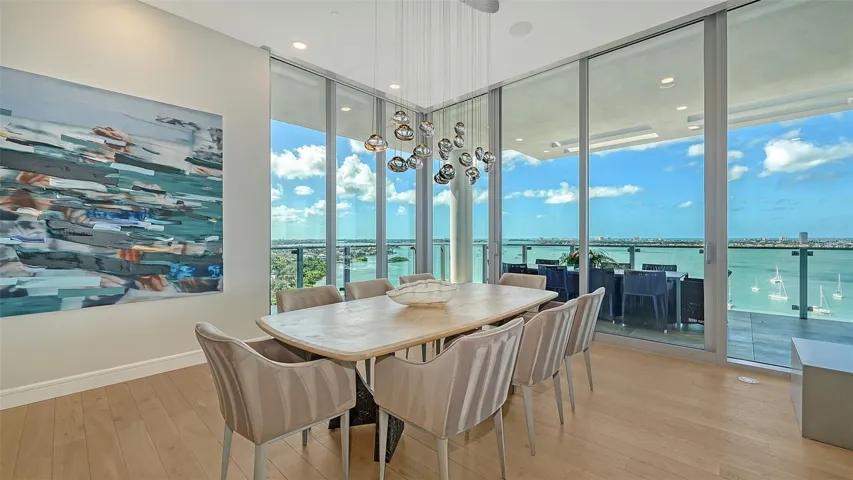 Ochre™ hand blown chandelier makes a statement in the dining area while offsetting the stunning blues of the sky and Gulf.