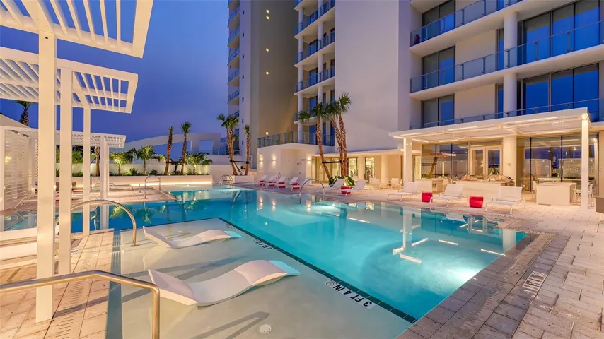 Resort-style pool terrace with 70’ lap pool, spa, cabanas, granite poolside bar, 2 gasgrills, dining areas, fire tables sit just outside the Resident's Club room