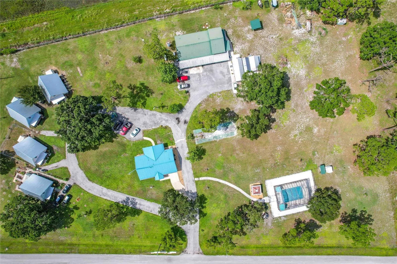 4 cottages on left, main home in middle, apartment in the back and pool to the right. Tons of space for up to 10 RV pads to the right and above pool area