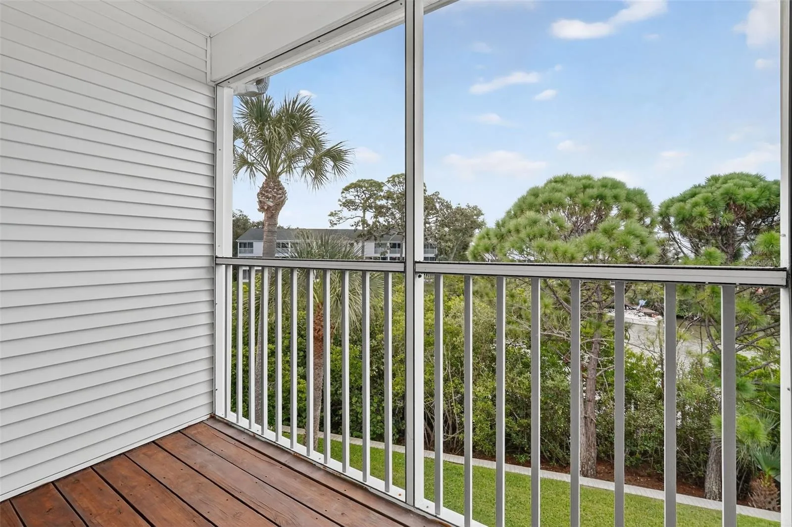 Private primary lanai with peaceful treetop and water views