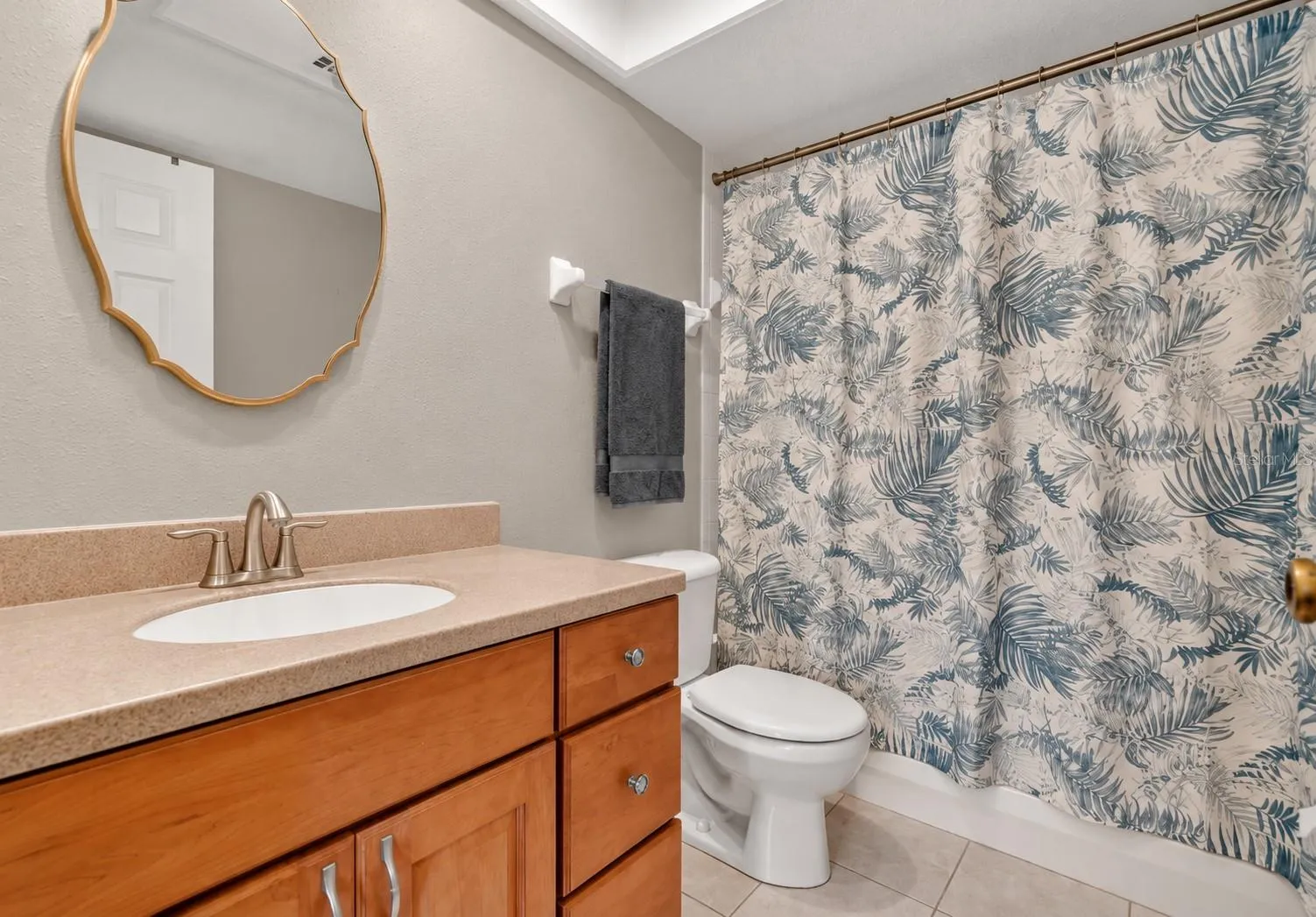 Private guest bath with refreshed neutral finishes