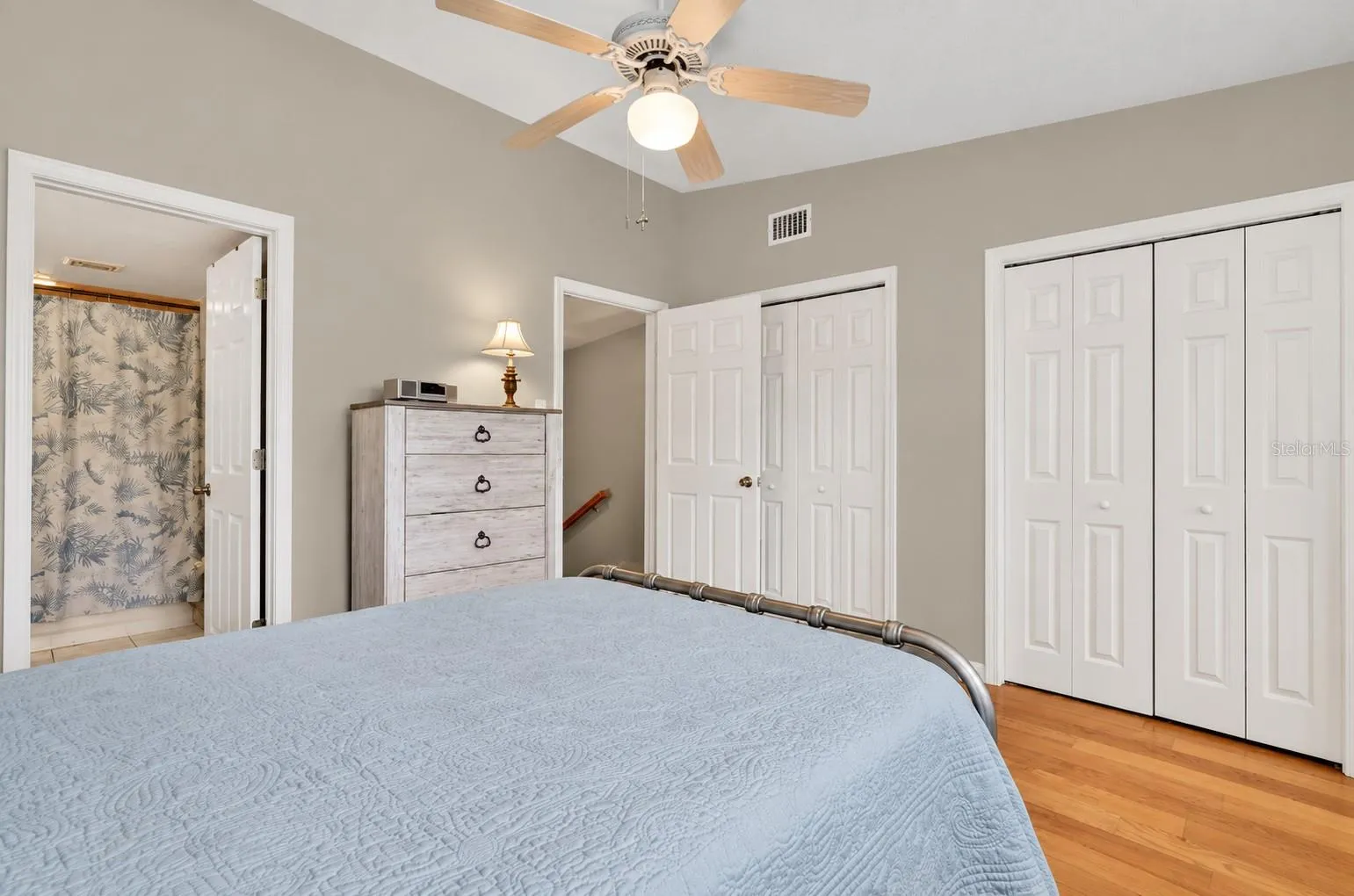 Guest suite with double closets and hardwood floors