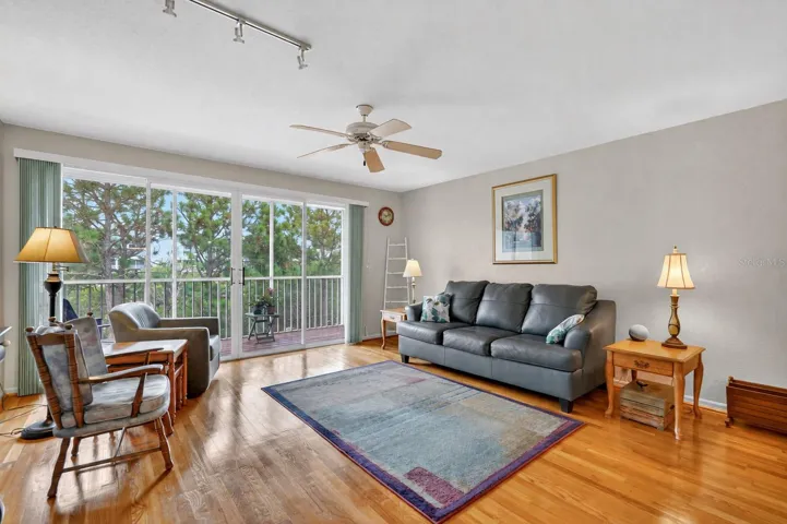 Living area overlooking the screened lanai, greenspace and canal