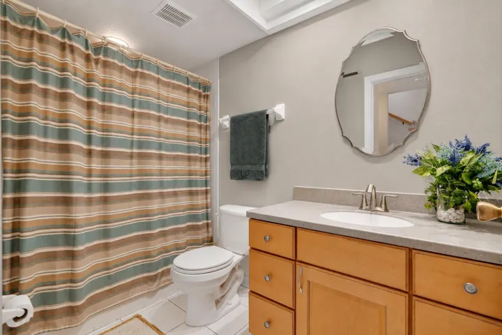 Downstairs full bath with refreshed neutral finishes