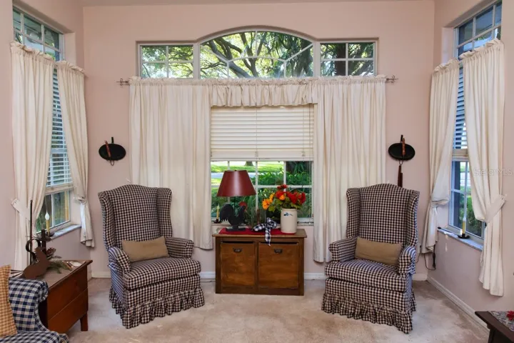 Charming sitting room boasting high ceilings and lots of natural light