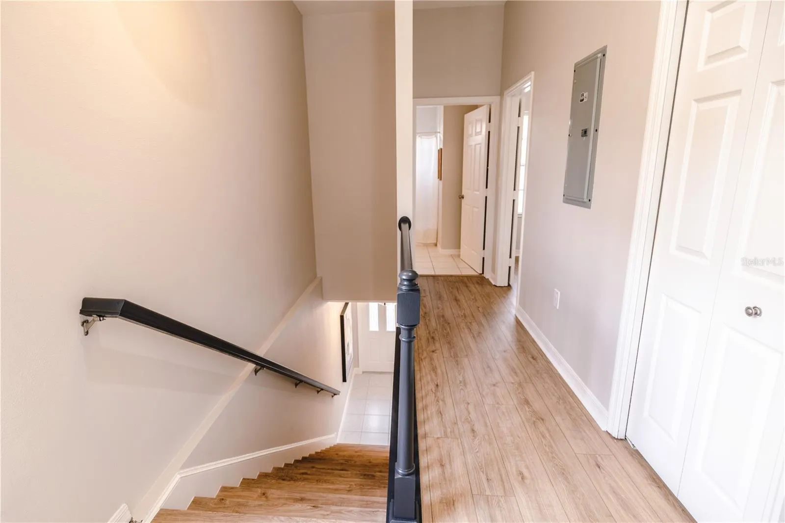 Beautiful hallway with clean lines creates a seamless flow to full bathroom and bedroom.