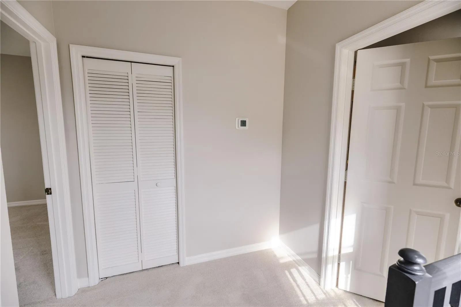 Quaint landing leading to primary bedroom