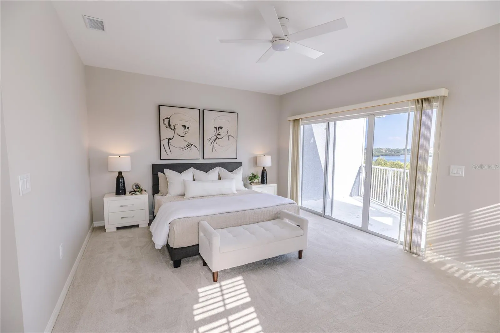 Spacious primary suite with elevated water views and private balcony.
