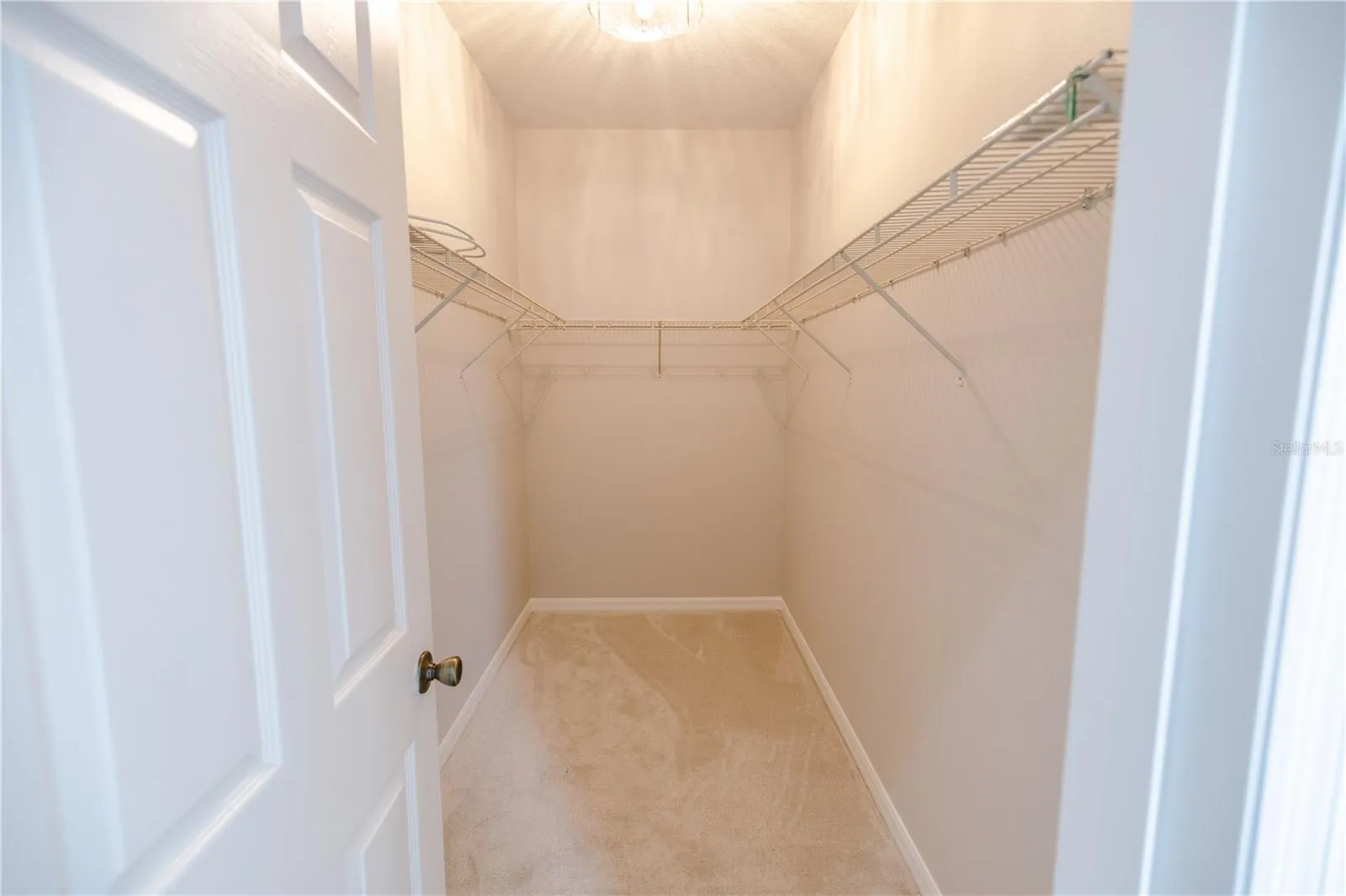 Spacious primary walk-in closet offering plenty of room for organization.