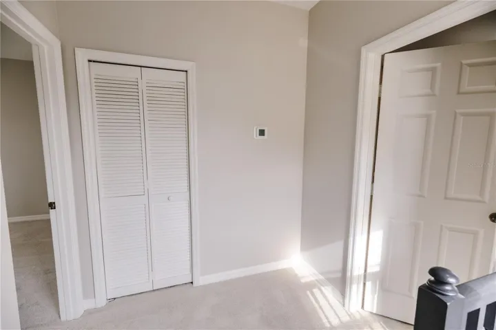 Quaint landing leading to primary bedroom