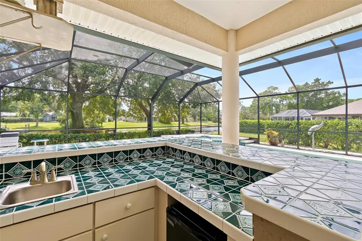Outdoor bar area with sink and fridge