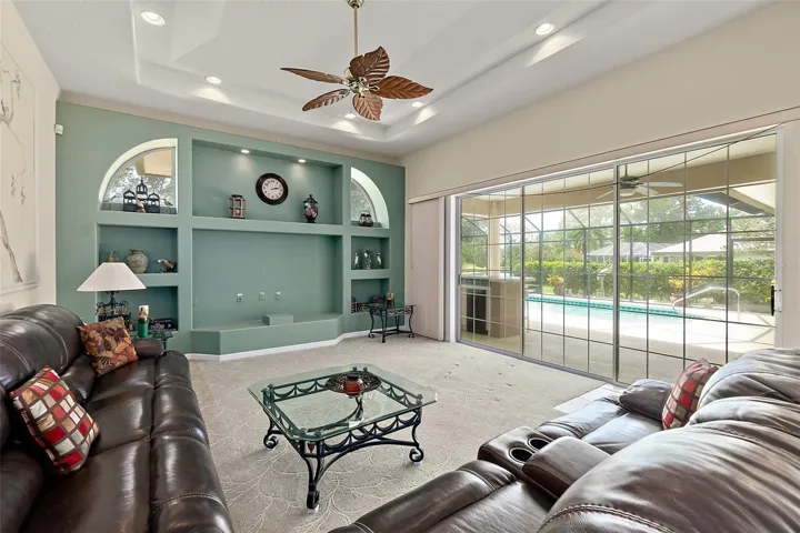 Family room with great patio, pool and water view