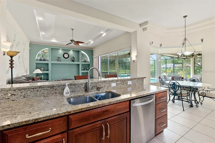 Kitchen overlooks family room and pool area