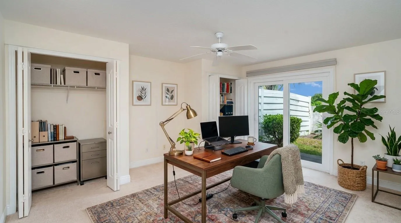 Second bedroom featuring a large window and built-in closet, ideal for a guest room or home office.