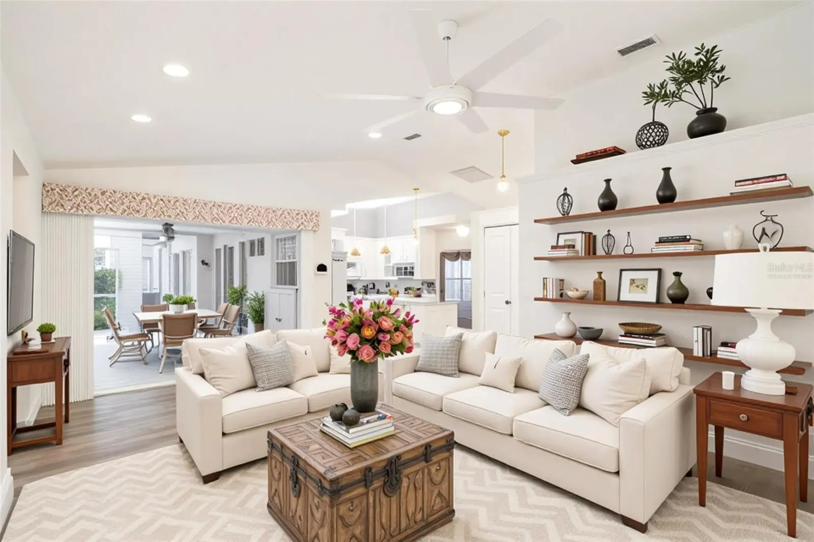 Virtually staged family room highlighting the open floor plan and seamless flow into the kitchen area.