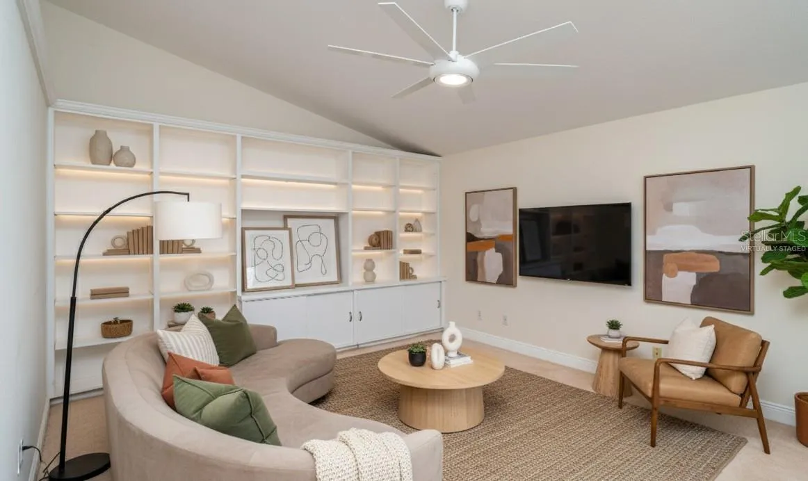 Bright and airy family room with tiled flooring, virtually staged to show a comfortable seating arrangement.