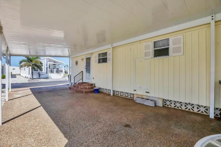 Under Carport & View of Side Entrance.