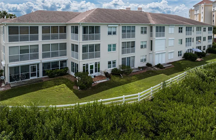 Rear elevation.  Unit is on the first floor with the enclosed lanai.