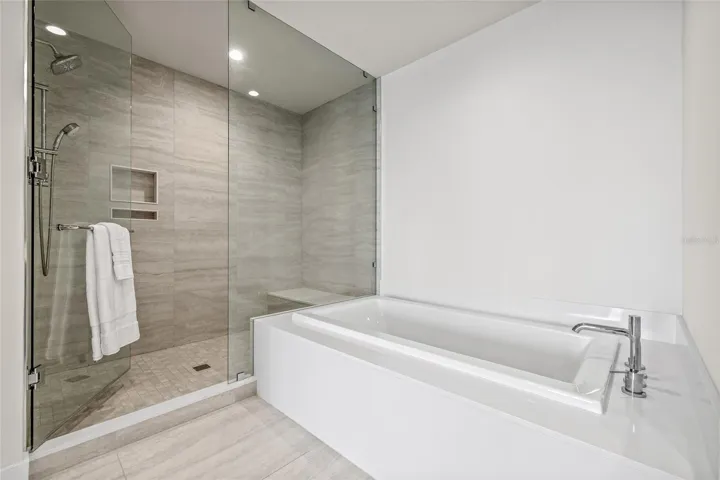 The spa-like bath features a spacious walk-in shower and a relaxing soaking tub.
