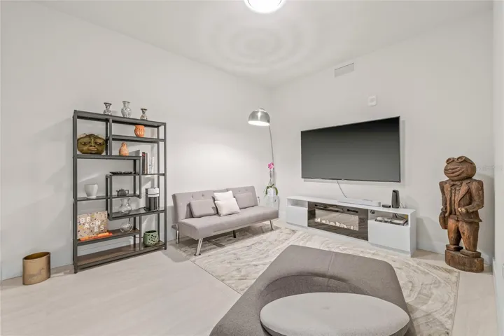 The versatile den offers flexible use as a home office, media room, or fitness space.