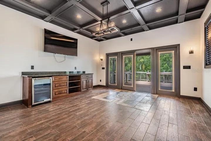 Upstairs Bonus Room with cabinetry and mini fridge, and a minisplit a/c