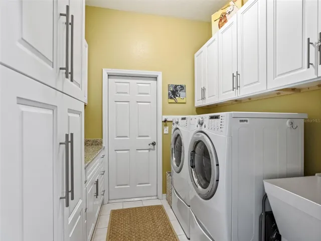 Laundry room with great STORAGE, utility sink and a counter space