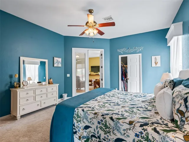 Primary bedroom with a walk in closet